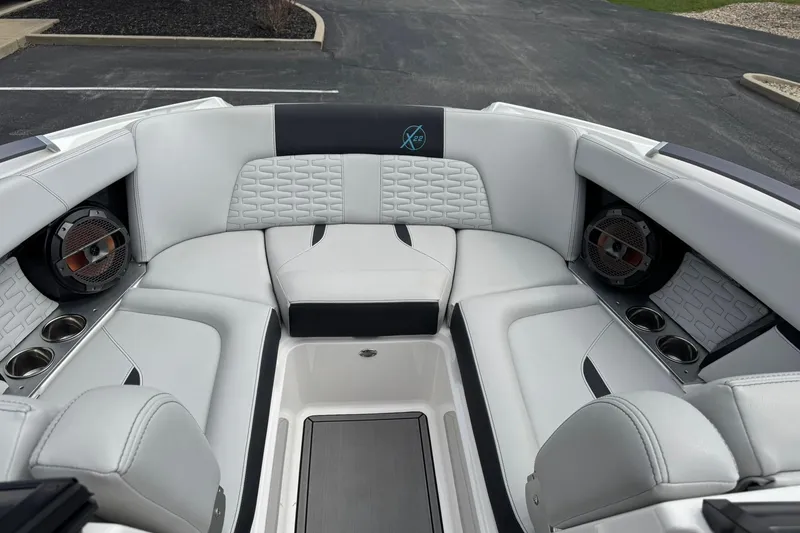 Slide: The Image of 2021 MasterCraft X22 boat interior with luxurious seating and built-in speakers. - 8