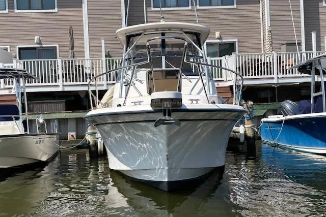 Slide: The Image of 2005 Grady White 282 Sailfish boat docked in marina, front view. - 2