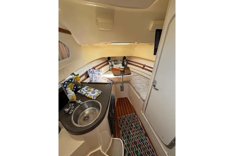 Slide: The Image of Interior of 2005 Grady White 282 Sailfish boat with kitchenette and seating area. - 8