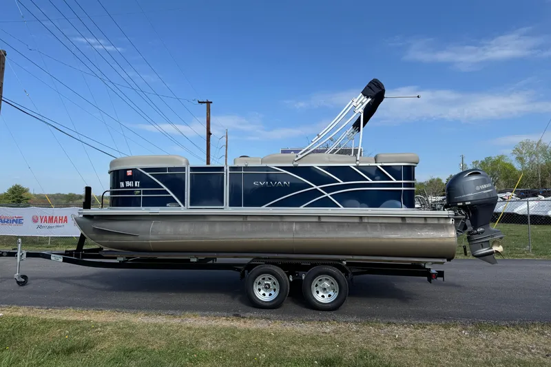 The Image of 2023 Sylvan Mirage 820 Cruise pontoon boat on trailer, blue sky background. - 1