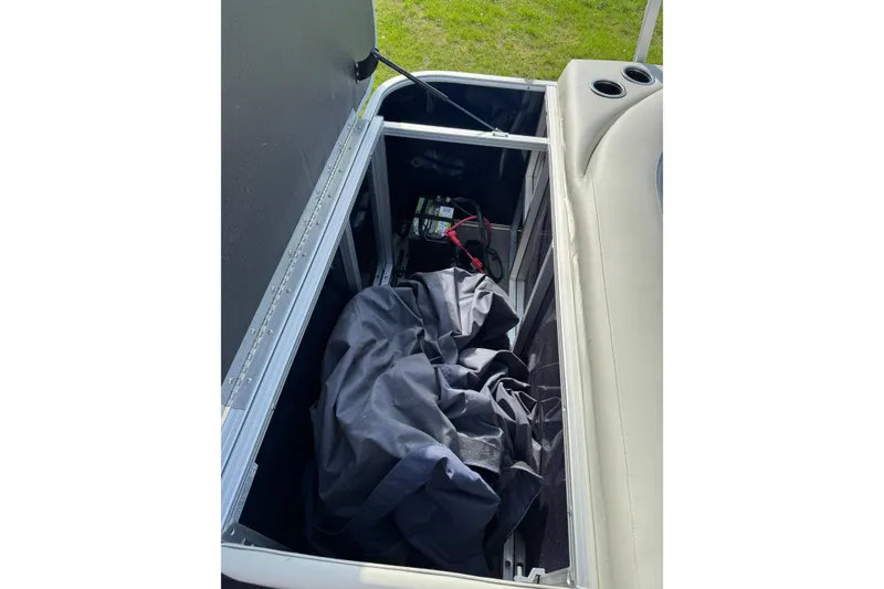 Slide: The Image of Storage compartment of 2023 Sylvan Mirage 820 Cruise boat with cover and battery. - 12