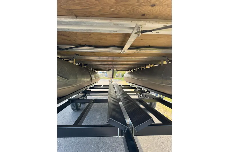 Slide: The Image of Underneath view of 2023 Sylvan Mirage 820 Cruise pontoon boat on a trailer. - 5