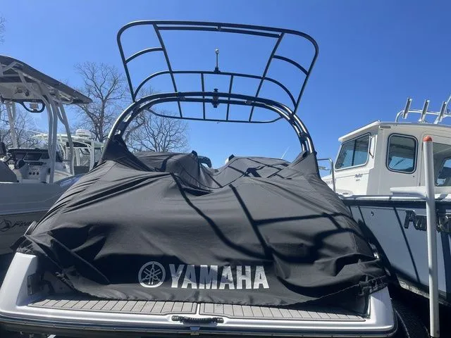 Slide: The Image of 2019 Yamaha 242 Limited S boat covered at dock. - 4