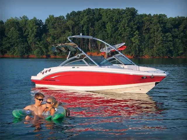 Slide: The Image of 2011 Chaparral 216 SSi boat on a lake with two people in the water. - 15