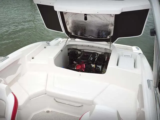Slide: The Image of Engine compartment of a 2011 Chaparral 216 SSi boat by the water. - 7