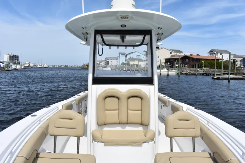 Slide: The Image of 2017 Sea Hunt Gamefish 27 boat with forward seating, docked in a marina. - 10