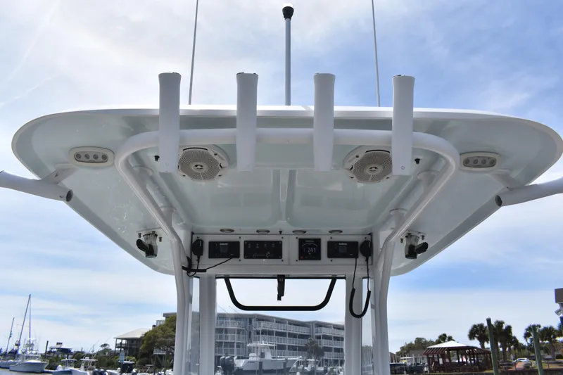 Slide: The Image of 2017 Sea Hunt Gamefish 27 boat's helm with T-top and rod holders. - 11