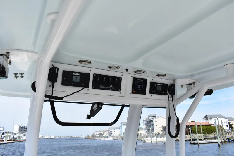 Slide: The Image of 2017 Sea Hunt Gamefish 27 dashboard with Simrad electronics, overlooking marina. - 15
