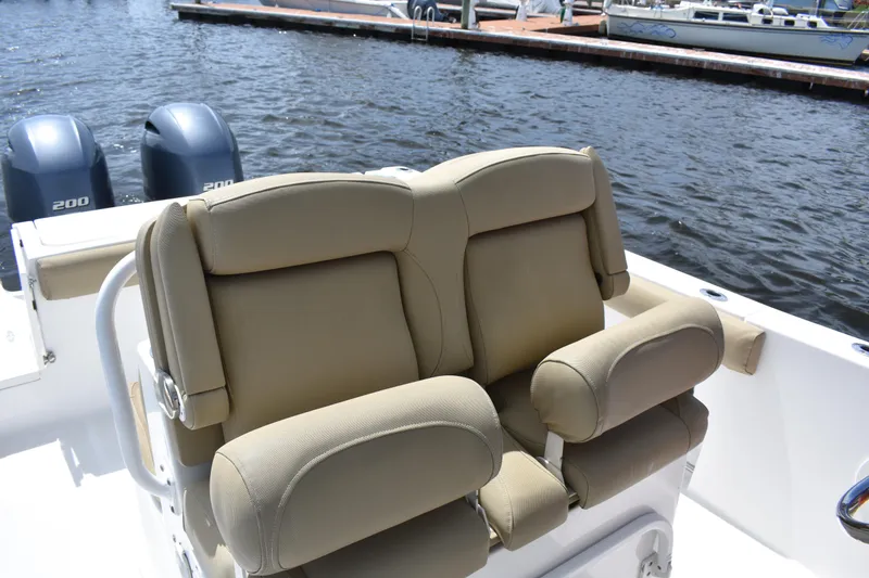 Slide: The Image of 2017 Sea Hunt Gamefish 27 boat with tan forward seating and dual engines. - 17