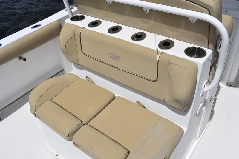 Slide: The Image of 2017 Sea Hunt Gamefish 27 boat seating with cup holders, beige upholstery. - 19