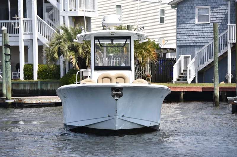 Slide: The Image of 2017 Sea Hunt Gamefish 27 boat docked near waterfront homes. - 3