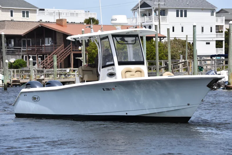 Slide: The Image of 2017 Sea Hunt Gamefish 27 boat docked near waterfront homes. - 5