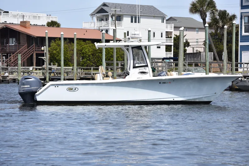 Slide: The Image of 2017 Sea Hunt Gamefish 27 boat docked near waterfront homes. - 6