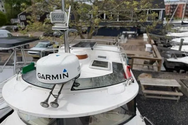 Slide: The Image of 2020 Ranger Tugs R-23 boat with Garmin radar, docked at a marina. - 14