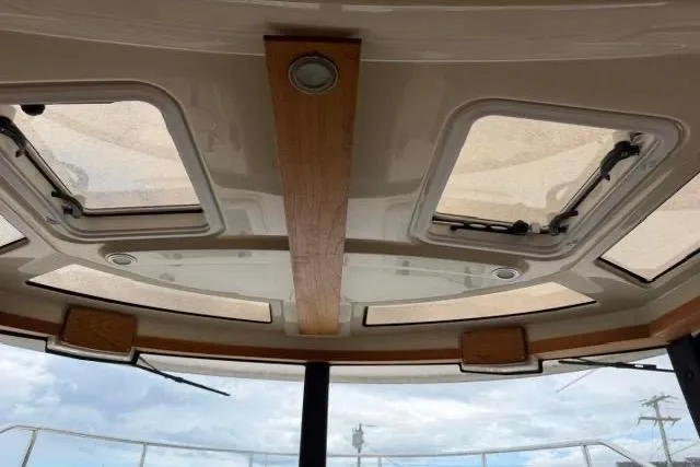 Slide: The Image of Interior view of 2020 Ranger Tugs R-23 boat ceiling with skylights and wooden accents. - 16
