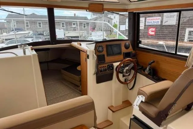 Slide: The Image of Interior of 2020 Ranger Tugs R-23 boat, featuring helm, seating, and navigation equipment. - 18