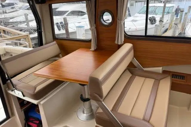Slide: The Image of Interior of 2020 Ranger Tugs R-23 boat with dining area and windows. - 21
