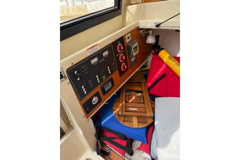 Slide: The Image of Control panel and safety equipment inside a 2020 Ranger Tugs R-23 boat. - 22