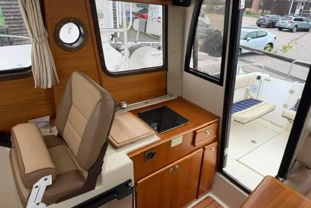 Slide: The Image of Interior of 2020 Ranger Tugs R-23 boat with seating and kitchenette area. - 23
