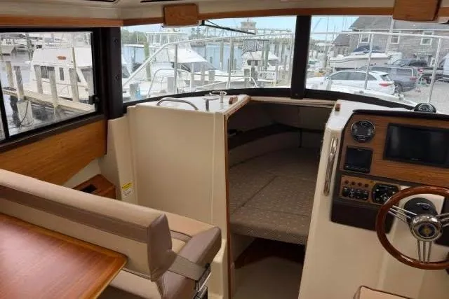 Slide: The Image of Interior of 2020 Ranger Tugs R-23 boat, featuring helm and seating area. - 36