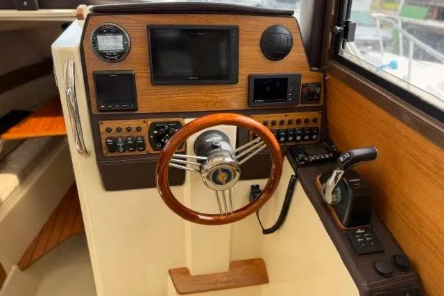 Slide: The Image of Cockpit of 2020 Ranger Tugs R-23 boat with wooden steering wheel and control panel. - 37
