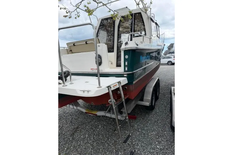 Slide: The Image of 2020 Ranger Tugs R-23 boat on trailer, rear view with ladder and open hatch. - 4