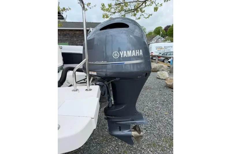 Slide: The Image of Yamaha outboard motor on a 2020 Ranger Tugs R-23 boat, parked on gravel. - 7