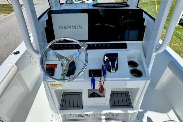 Slide: The Image of 2022 Sea Hunt BX 25 FS boat console with Garmin navigation system and steering wheel. - 10