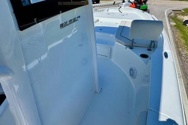 Slide: The Image of 2022 Sea Hunt BX 25 FS boat interior, showcasing sleek design and spacious seating area. - 15