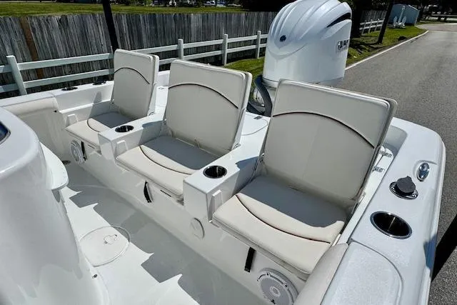 Slide: The Image of 2022 Sea Hunt BX 25 FS boat with three cushioned seats and Yamaha outboard motor. - 7