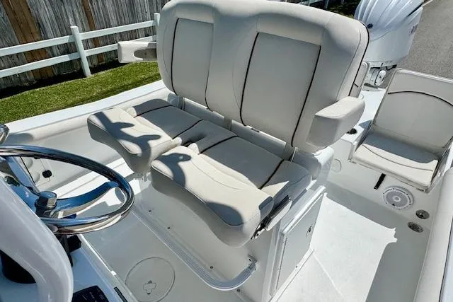 Slide: The Image of 2022 Sea Hunt BX 25 FS boat interior with plush seating and steering wheel. - 9