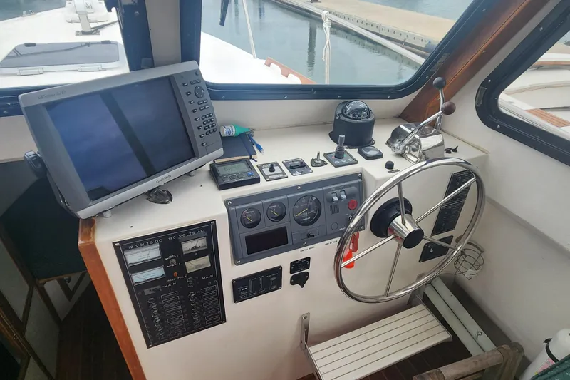 Slide: The Image of Helm of 2001 Eastern 31 Casco Bay boat with navigation equipment and steering wheel. - 12