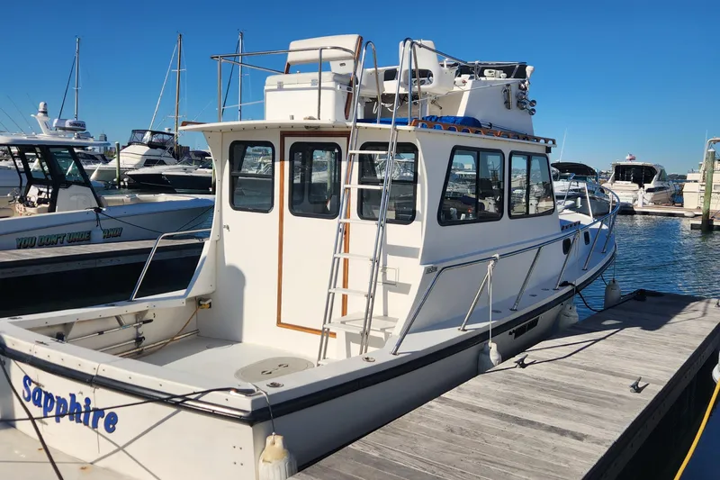 Slide: The Image of 2001 Eastern 31 Casco Bay boat docked at marina under clear blue sky. - 2