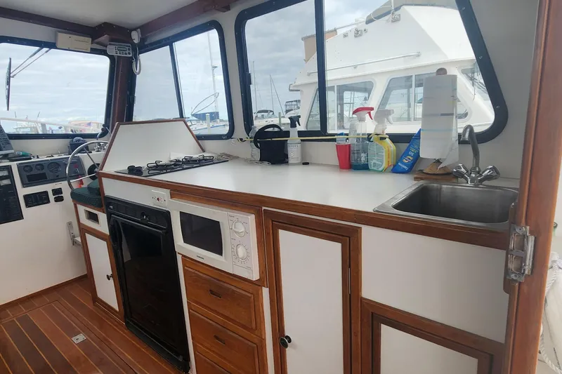Slide: The Image of Interior of 2001 Eastern 31 Casco Bay boat with kitchen and steering area. - 8