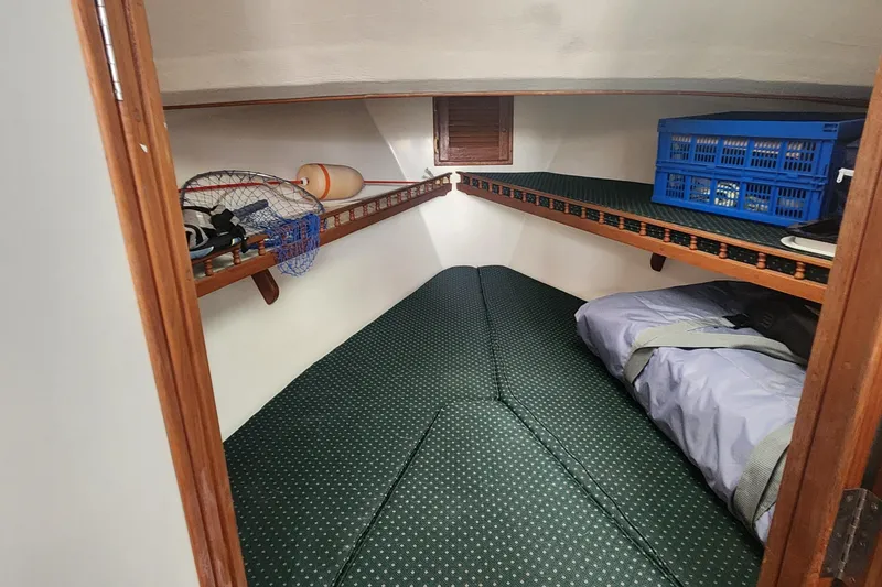 Slide: The Image of Cozy cabin interior of 2001 Eastern 31 Casco Bay boat with storage shelves. - 9