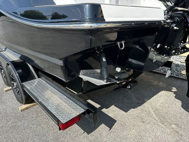 Slide: The Image of 2024 Starcraft SVX 231 OB boat with trailer, black rear view. - 12