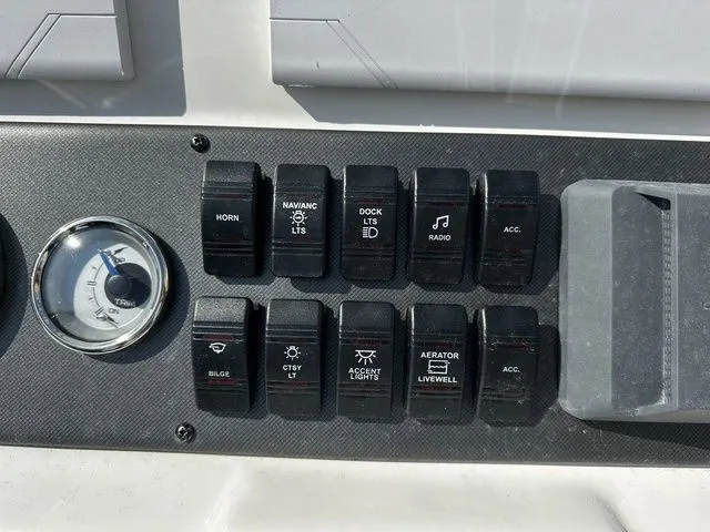 Slide: The Image of Dashboard of Starcraft SVX 231 OB boat with switches and gauge. - 20