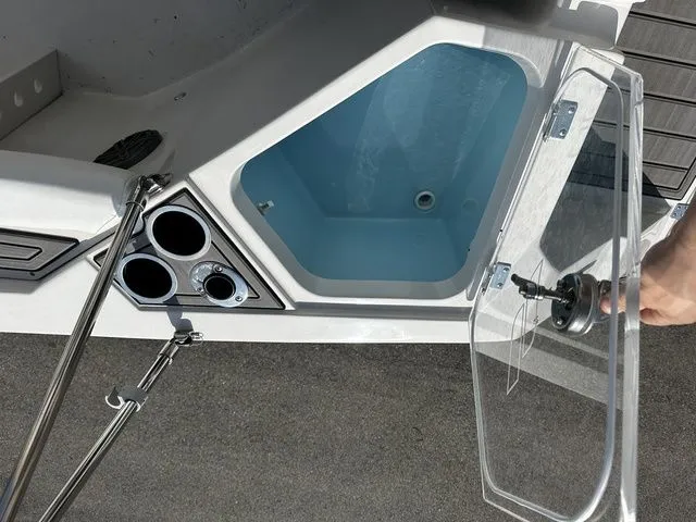 Slide: The Image of Starcraft 2024 boat with open storage compartment and cup holders. - 24
