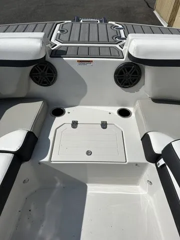 Slide: The Image of 2024 Starcraft SVX 231 OB boat interior with speakers and storage. - 31