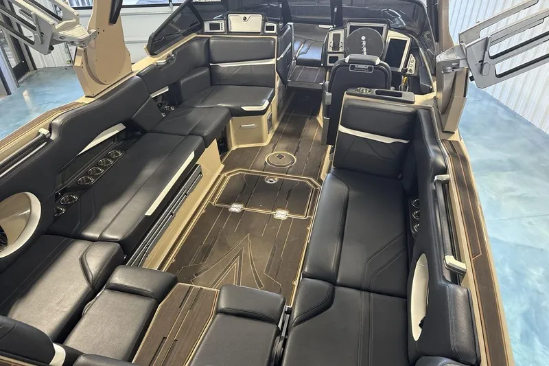 Slide: The Image of 2023 Supra SE 550 boat interior with luxurious black seating and modern design. - 10