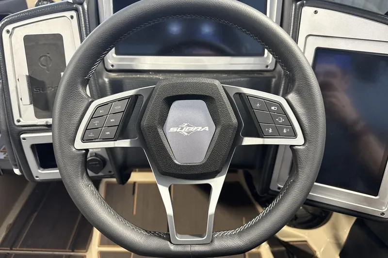 Slide: The Image of Steering wheel of 2023 Supra SE 550 with control buttons and logo. - 14