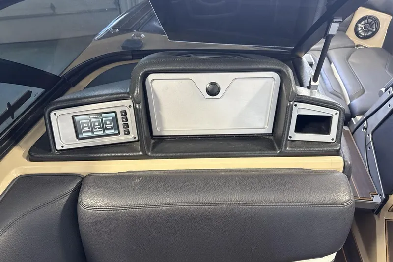 Slide: The Image of 2023 Supra SE 550 boat dashboard with control panel and storage compartments. - 18