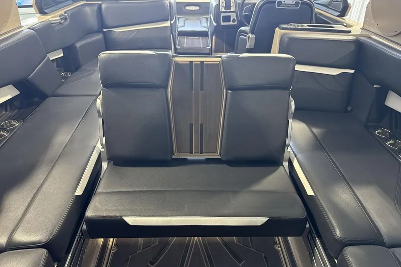 Slide: The Image of Luxurious interior seating of 2023 Supra SE 550 boat with sleek black upholstery. - 24