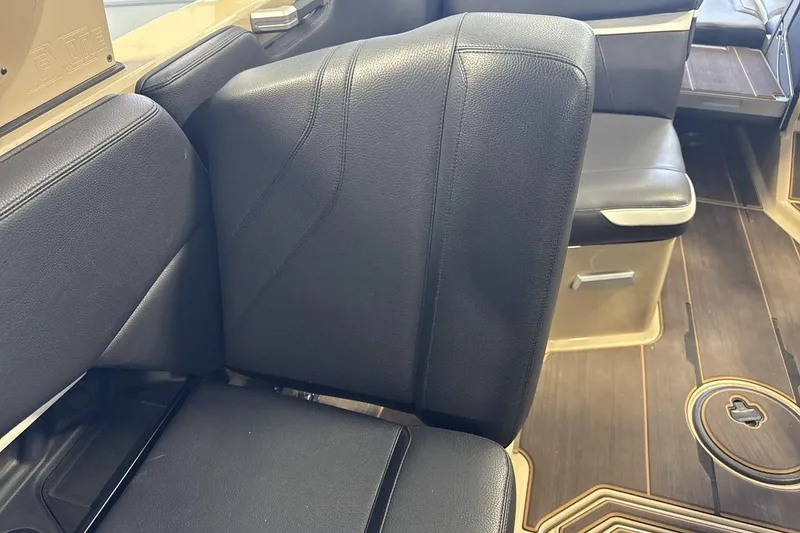 Slide: The Image of 2023 Supra SE 550 interior with black leather seating and wood flooring. - 25