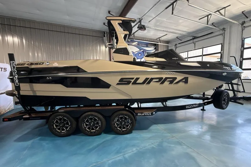 Slide: The Image of 2023 Supra SE 550 boat on trailer in indoor showroom. - 7