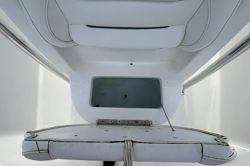 Slide: The Image of 2016 Sea Hunt Ultra 225 boat interior with storage compartment and seating. - 10