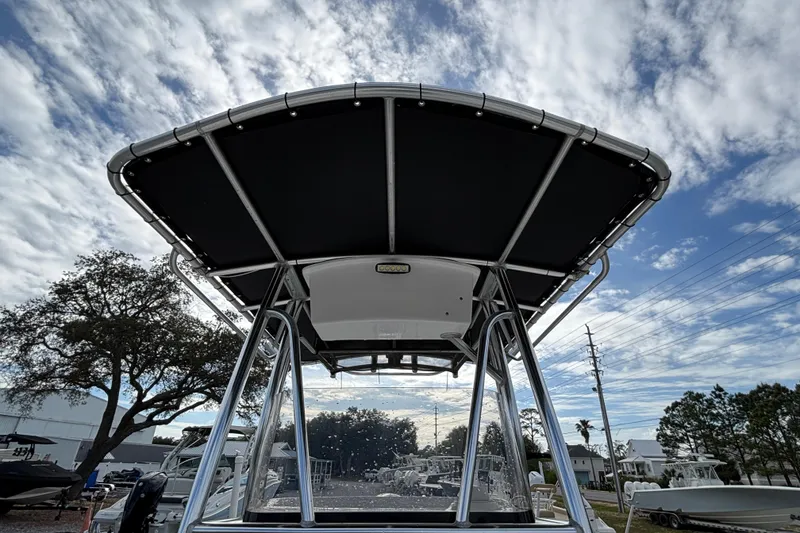 Slide: The Image of 2016 Sea Hunt Ultra 225 boat with T-top against a cloudy sky background. - 11