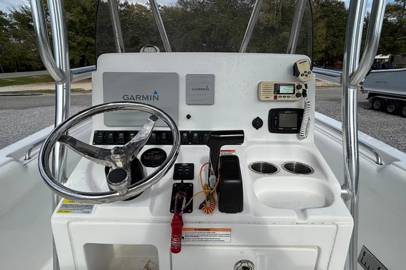 Slide: The Image of 2016 Sea Hunt Ultra 225 boat console with Garmin navigation, steering wheel, and communication devices. - 12