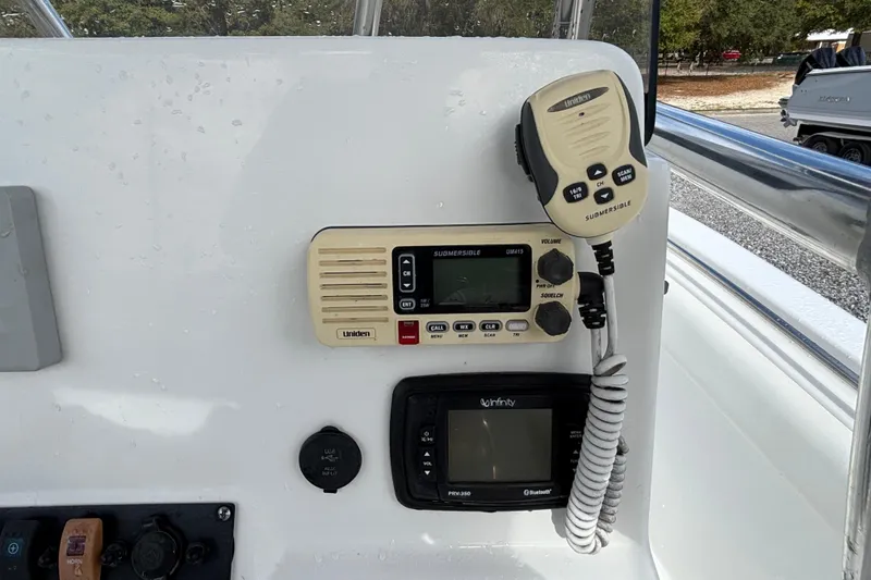 Slide: The Image of Control panel of a 2016 Sea Hunt Ultra 225 boat with radio and display. - 14