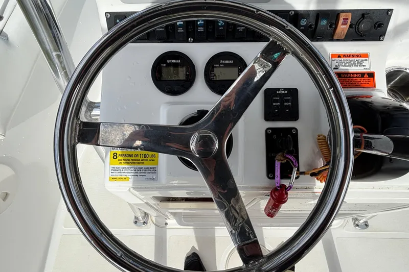 Slide: The Image of Steering console of a 2016 Sea Hunt Ultra 225 boat with gauges and controls. - 15